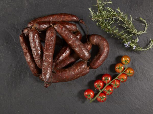 Chorizo Ristra de chorizos con tomates en fondo negro